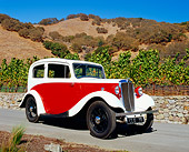 AUT 19 RK0593 01
1935 Morris Eight Red And White 3/4 Side Viwe On Pavement By Hills And Trees