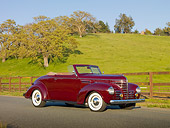 AUT 19 RK0777 01
1939 Plymouth P8 Convertible Dark Cranberry 3/4 Side View On Pavement By Fence And Grassy Hill