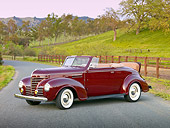AUT 19 RK0779 01
1939 Plymouth P8 Convertible Dark Cranberry 3/4 Front View On Pavement By Fence And Grassy Hill