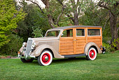 AUT 19 RK0847 01
1935 Ford Woodie Beige 3/4 Side View On Grass By Trees