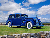 AUT 19 RK0870 01
1937 Packard Super Eight Sedan Blue 3/4 Side View On Grass Against Blue Sky