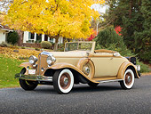AUT 19 RK0873 01
1932 Chrysler Convertible Coupe Beige 3/4 Front View On Pavement By House And Autumn Trees