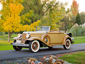 AUT 19 RK0876 01
1932 Chrysler Convertible Coupe Beige 3/4 Front View On Pavement By Grass And Autumn Trees