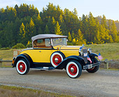 AUT 19 RK0901 01
1930 Ford Model A Yellow 3/4 Side View On Gravel By Grass Field And Trees