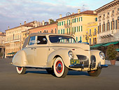AUT 19 RK0922 01
1939 Lincoln Zephyr Convertible Cream 3/4 Front View On Pavement By Buildings