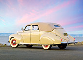 AUT 19 RK0927 01
1939 Lincoln Zephyr Convertible Cream 3/4 Rear View On Pavement By Water At Dusk