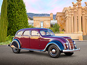 AUT 19 RK1025 01
1935 Chrysler C2 Airflow Imperial Maroon And Black 3/4 Side View On Pavement By Building With Pillars