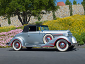 AUT 19 RK1034 01
1934 Pontiac Convertible Silver With Red Trim Profile View On Pavement By Trees And Flowers