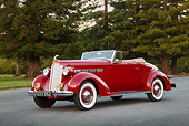 AUT 19 RK1058 01
1937 Packard 120 Convertible Coupe Red 3/4 Front View On Pavement By Trees
