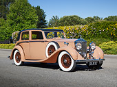 AUT 19 RK1067 01
1937 Rolls-Royce 25/30 James Young Saloon Tan 3/4 Front View On Pavement By Shrubs