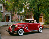 AUT 19 RK0043 04
1936 Auburn Cabriolet Red Side 3/4 View On Pavement By House And Trees