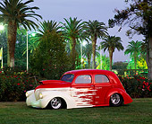 AUT 19 RK0118 04
1937 Willys 2-Door Red And White 3/4 Side View On Grass By Trees