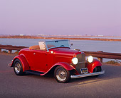 AUT 19 RK0194 01
1932 Ford Roadster Maroon Front 3/4 View On Road Bay Background At Dusk
