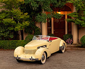 AUT 19 RK0239 06
1937 Cord 812 Supercharged Phaeton Convertible Yellow Front 3/4 View By Trees