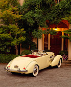 AUT 19 RK0240 08
1937 Cord 812 Supercharged Phaeton Convertible Yellow Rear 3/4 View By Trees