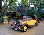 AUT 19 RK0250 04
1936 Gurney Nutting Drophead Coupe Bentley 3/4 Front View On Pavement By House And Trees