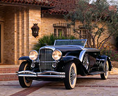AUT 19 RK0251 05
1930 Black Duesenberg (Murphy Body) 3/4 Front View On Driveway By House