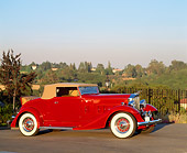 AUT 19 RK0276 01
1933 Packard 1001 Coupe Red  3/4 Front View On Pavement Trees Blue Sky