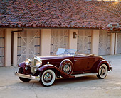 AUT 19 RK0279 04
1932 Packard Dietrich 8C Convertible Burgundy 3/4 Front View By Garage