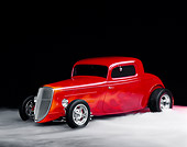 AUT 19 RK0289 11
1934 Ford Coupe Red With Flames 3/4 Front View On Foggy Floor Studio