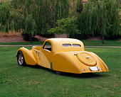 AUT 19 RK0344 01
1937 Bugatti Type 57 Atlante Coupe Yellow 3/4 Rear View On Grass