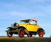 AUT 19 RK0394 03
1931 Ford Model A Deluxe Roadster Yellow Low 3/4 Front View On Dirt Blue Sky