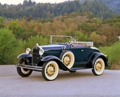AUT 19 RK0403 15
1931 Ford Model A Deluxe Roadster Blue 3/4 Front View On Pavement By Trees And Bushes