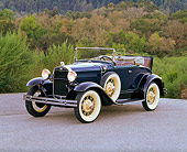 AUT 19 RK0405 03
1931 Ford Model A Deluxe Roadster Blue 3/4 Side View On Pavement By Trees And Bushes