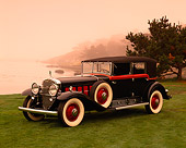 AUT 19 RK0430 01
1930 Cadillac V16 Black And Red 3/4 Side View On Grass By Water Red Sky Pebble Beach