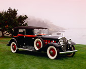 AUT 19 RK0430 02
1930 Cadillac V16 Black And Red 3/4 Side View On Grass By Water Red Sky Pebble Beach