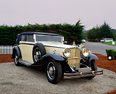 AUT 19 RK0454 01
1932 Maybach Zeppelin DS8 Yellow 3/4 Front View On Pavement By Bushes