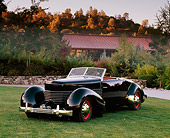AUT 19 RK0467 01
1936 Cord 810 Phaeton Black 3/4 Front View On Grass By Trees At Dusk