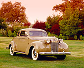 AUT 19 RK0603 01
1937 Chrysler Imperial Light Gold 3/4 Front View On Grass By Trees Filtered