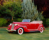 AUT 19 RK0614 03
1935 Auburn 851 Supercharged Convertible Red And Cream Side 3/4 View On Grass By Trees