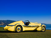 AUT 19 RK0671 01
1935 Duesenberg SJ Speedster Yellow Rear 3/4 On Grass Sky Water Mountain