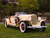 AUT 19 RK0687 01
1932 Auburn V-12 Boattail Speedster 160 Yellow And Maroon Front 3/4 View On Grass By Trees