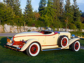 AUT 19 RK0688 01
1932 Auburn V-12 Boattail Speedster 160 Yellow And Maroon Rear 3/4 View On Grass By Trees Wall Sky