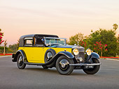 AUT 19 RK0705 01
1931 Rolls-Royce Phantom II Yellow And Black 3/4 Front View On Pavement By Trees