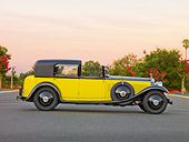 AUT 19 RK0706 01
1931 Rolls-Royce Phantom II Yellow And Black Profile View On Pavement By Trees