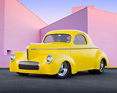 AUT 20 BK0003 01
1941 Willys Coupe Yellow 3/4 Front View On Pavement By Pink Building