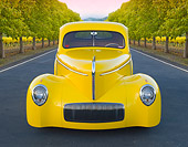 AUT 20 BK0004 01
1941 Willys Coupe Yellow Front View On Pavement By Row Of Trees