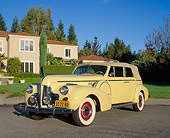 AUT 20 RK0203 02
1940 Buick Phaeton Limited Convertible Yellow 3/4 Front View On Pavement By House