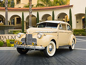 AUT 20 RK0427 01
1940 Chevrolet Special Deluxe Coupe Tan 3/4 Front View On Pavement By Building