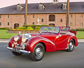 AUT 20 RK0578 01
1949 Triumph 2000 Roadster Red 3/4 Front View On Pavement By Brick Building