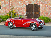 AUT 20 RK0579 01
1949 Triumph 2000 Roadster Red 3/4 Side View On Pavement By Brick Building