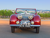 AUT 20 RK0580 01
1949 Triumph 2000 Roadster Red Front View On Pavement By Vineyard