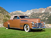 AUT 20 RK0583 01
1941 Cadillac Series 62 Convertible Gold 3/4 Front View On Grass By Mountains