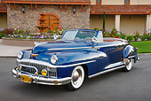 AUT 20 RK0614 01
1948 DeSoto Custom Regal Blue 3/4 Front View On Pavement By Building