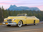 AUT 20 RK0641 01
1947 Lincoln Continental Yellow 3/4 Front View On Pavement By Evergreen Trees At Dusk