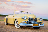 AUT 20 RK0645 01
1947 Lincoln Continental Yellow 3/4 Front View On Dry Grass By Vineyard